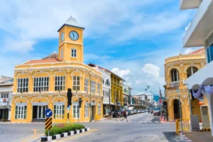 a yellow building with a clock tower on the corner of a street